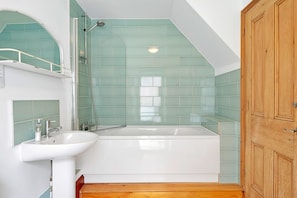 A bathroom with a white sink, a bathtub, and a shower. - Haven Near Dartmouth Ferry (Dartmouth)