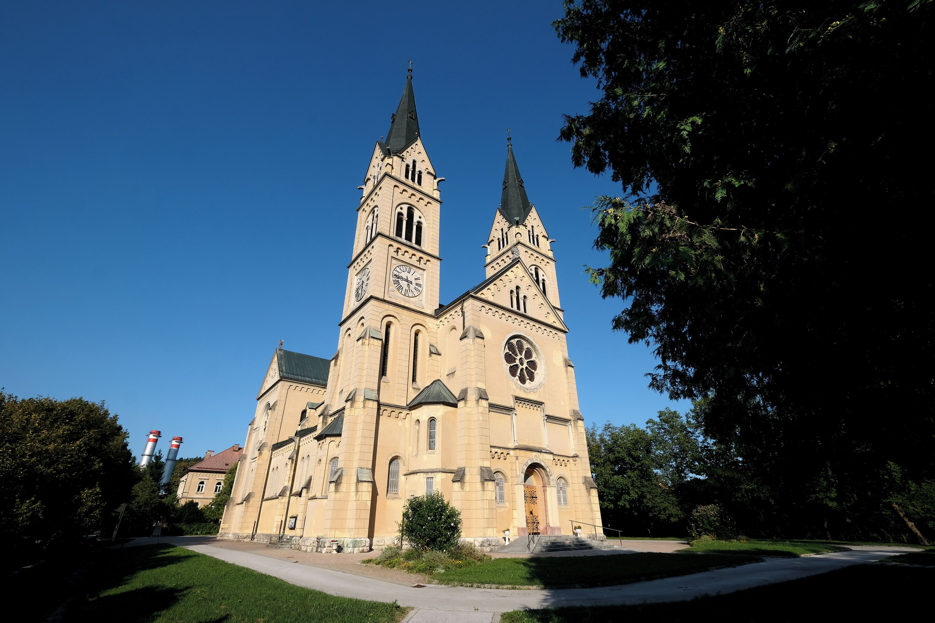 A large church with two towers, a central clock, and a large rose window.