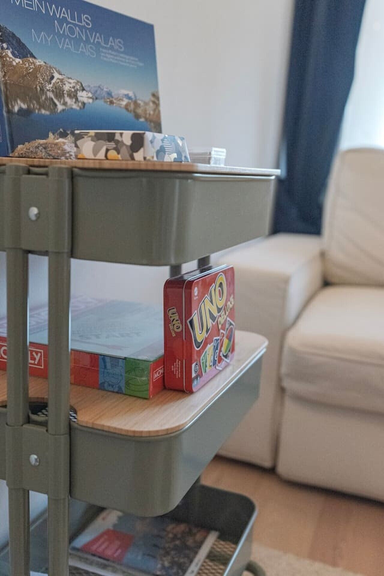 A metal shelf with books and a game box.