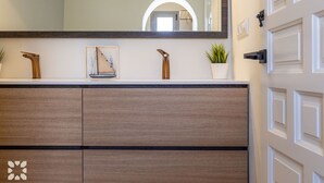 A bathroom vanity with a mirror, a small sailboat decoration, and a potted plant. - PALMERAS DEL MAR Villa by Abahana Villas (Teulada)
