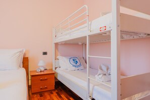 A bunk bed room with a wooden nightstand, a lamp, and a clock. - SG Family - Casa Bertolini (Castelnuovo del Garda)