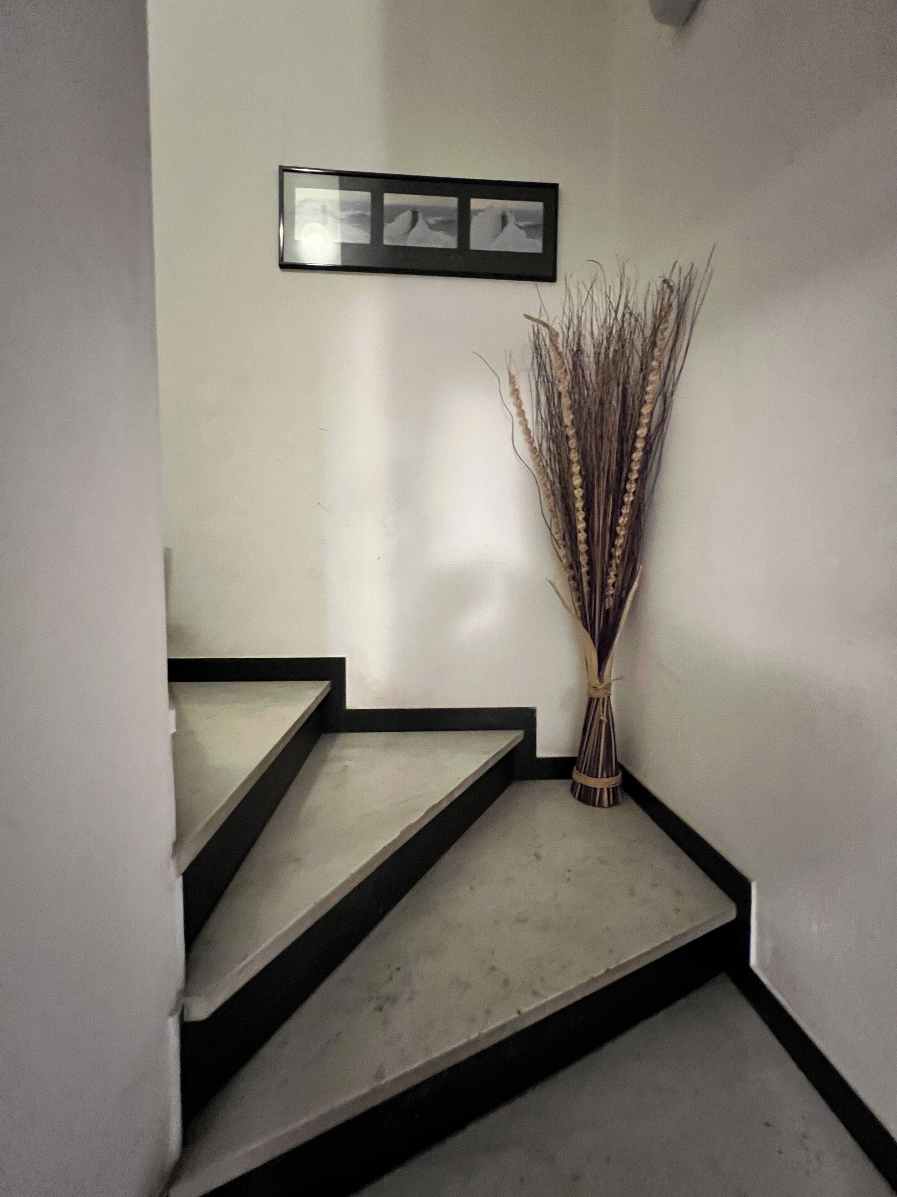 A staircase with a framed picture above it.