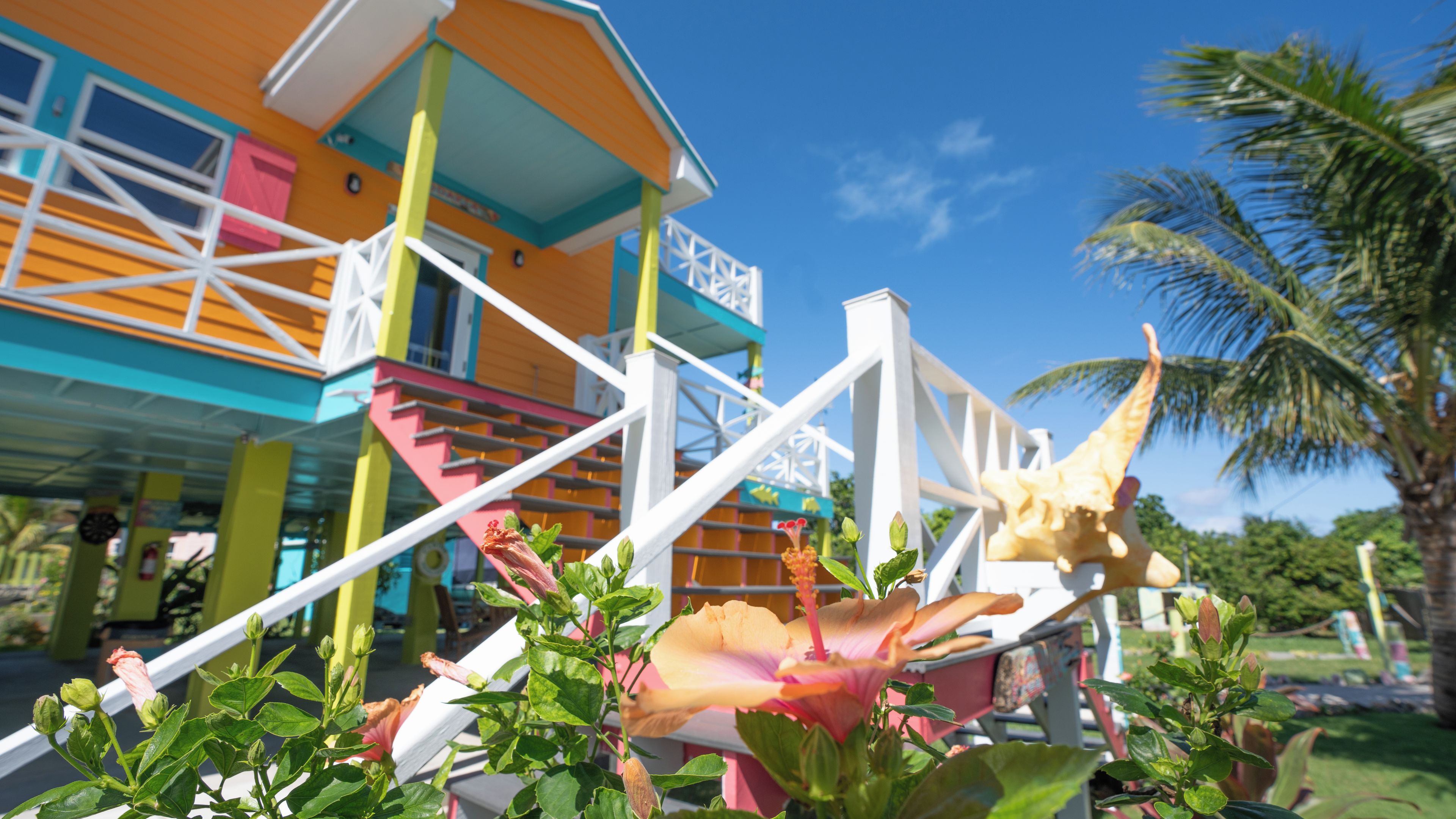 A colorful building with a staircase and a large ice cream cone sculpture.