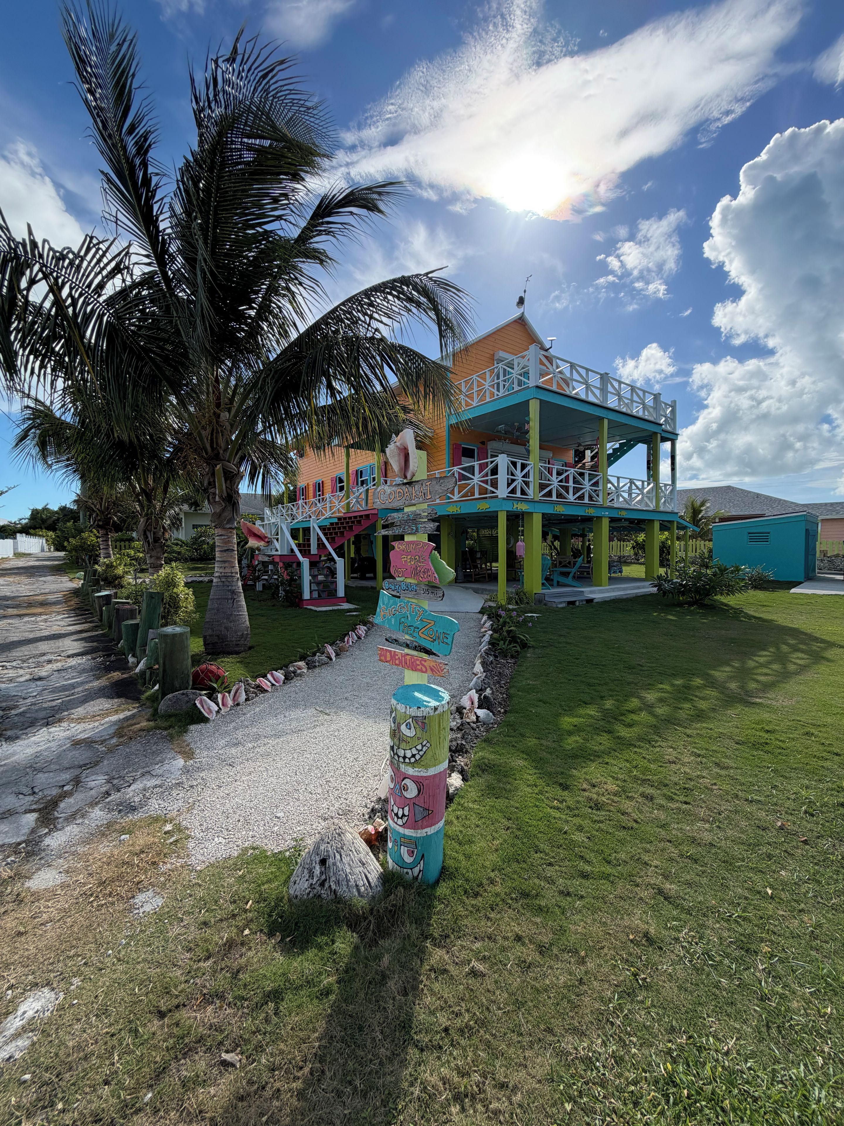 A colorful building with a sign reading 'Cody's' and a palm tree in the foreground.