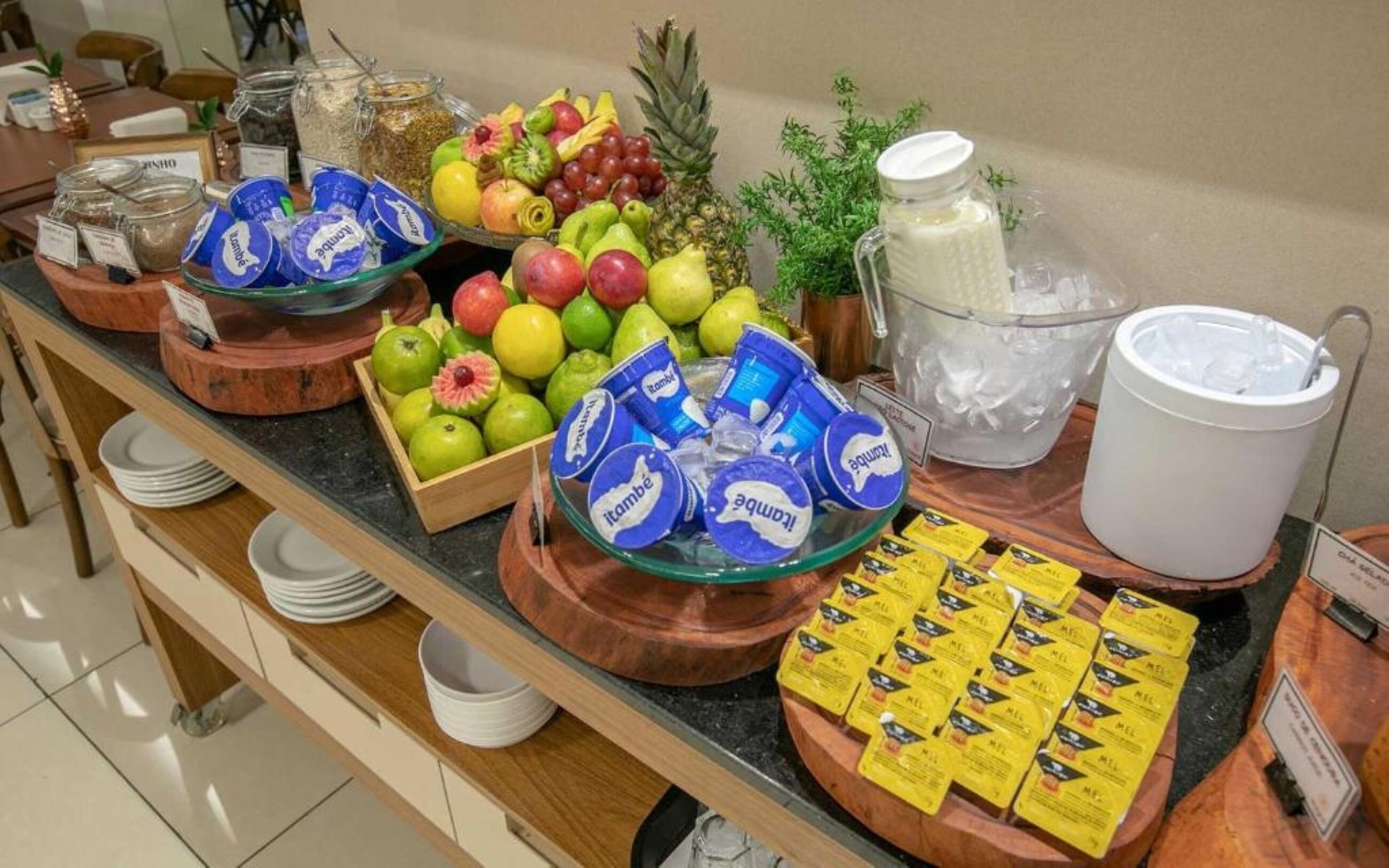 A buffet with fruits, yogurt, and cereal.