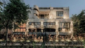 A modern building with multiple levels, large windows, and a central courtyard with a sculpture. - Rooftop Pool, Spa! Luxury 4BR Designer Tulum Villa (Tulum)