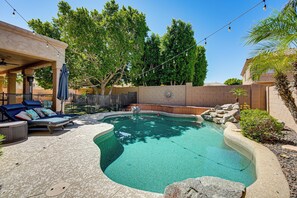 A swimming pool with a curved edge, surrounded by lounge chairs and a covered seating area. - Outdoor Oasis w/ Pool! Glendale Group Escape (Glendale)