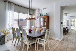A dining area with a dark wooden table, six chairs, and a large mirror above the table. - Outdoor Oasis w/ Pool! Glendale Group Escape (Glendale)