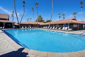 A swimming pool with lounge chairs and palm trees. - Complimentary Golf Cart! Viewpoint Resort Home (Mesa)