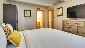 A hotel room with a bed, a television, a wardrobe, and a door leading to a bathroom. - Hike, Bike & Ski! Cozy Condo 8 Mi to Lake Dillon (Breckenridge)