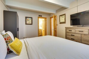 A hotel room with a bed, a television, a wardrobe, and a door leading to a bathroom. - Hike, Bike & Ski! Cozy Condo 8 Mi to Lake Dillon (Breckenridge)