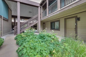 A building with a covered walkway, a staircase, and a door. - Hike, Bike & Ski! Cozy Condo 8 Mi to Lake Dillon (Breckenridge)