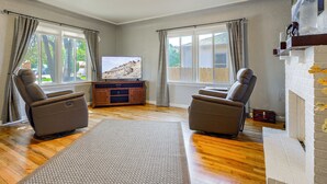 A living room with two leather recliners, a television, and a fireplace. - Near Riverwalk & Lake Adventures! Pueblo Home (Pueblo)