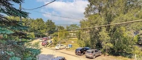 A parking area with multiple cars and a wooden fence.
