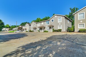A row of townhouses with a driveway and a parked car.