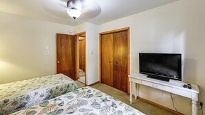 A bedroom with two beds, a ceiling fan, a TV on a stand, and wooden wardrobes. - Lewes Family Escape w/ Angola by the Bay Amenities (Lewes)
