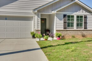 A residential house with a garage, a front porch with potted plants, and a brick foundation. - Lake Hartwell Home Base: 2 Mi to Marina! (Hartwell)