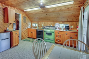 Una cocina con armarios de madera, lavavajillas, estufa y cafetera.