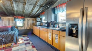 A compact kitchen with a refrigerator, microwave, and coffee maker. - Cast & Relax! Lake-view Fishing Cabin in Monmouth (Monmouth)
