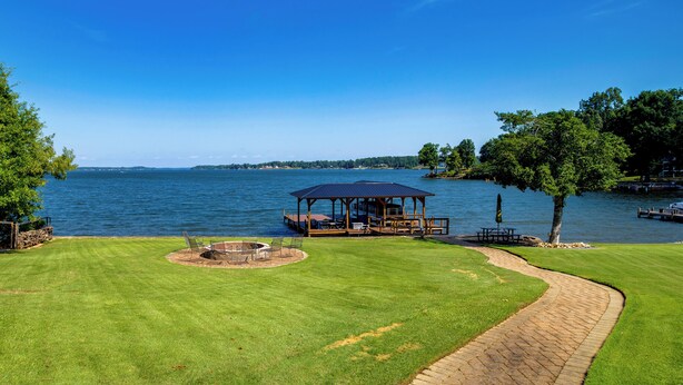 A lakeside deck with a gazebo, a fire pit, and a paved walkway. - Cast & Relax! Lake Greenwood Stay w/ Dock Access (Chappells)