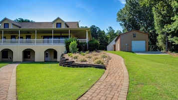 A two-story house with a covered porch and a garage.