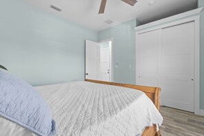 Ein Schlafzimmer mit einem Bett, einer Tür und einem Kleiderschrank.