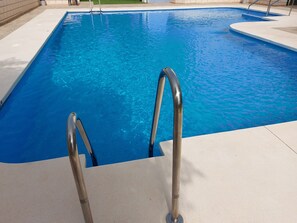 A swimming pool with a metal ladder leading into the water. - SPACIOUS APARTMENT 100 METERS FROM THE BEACH IN NERJA (Nerja)