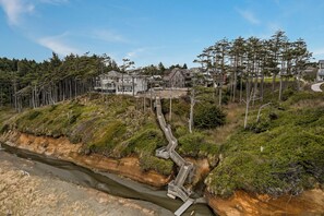 A coastal residential area with houses, a winding pathway, and a river. - Seabrook Newhart | Hot Tub, Sauna, Cold Plunge 9BR | Sleeps 18, Garage Parking (Pacific Beach)
