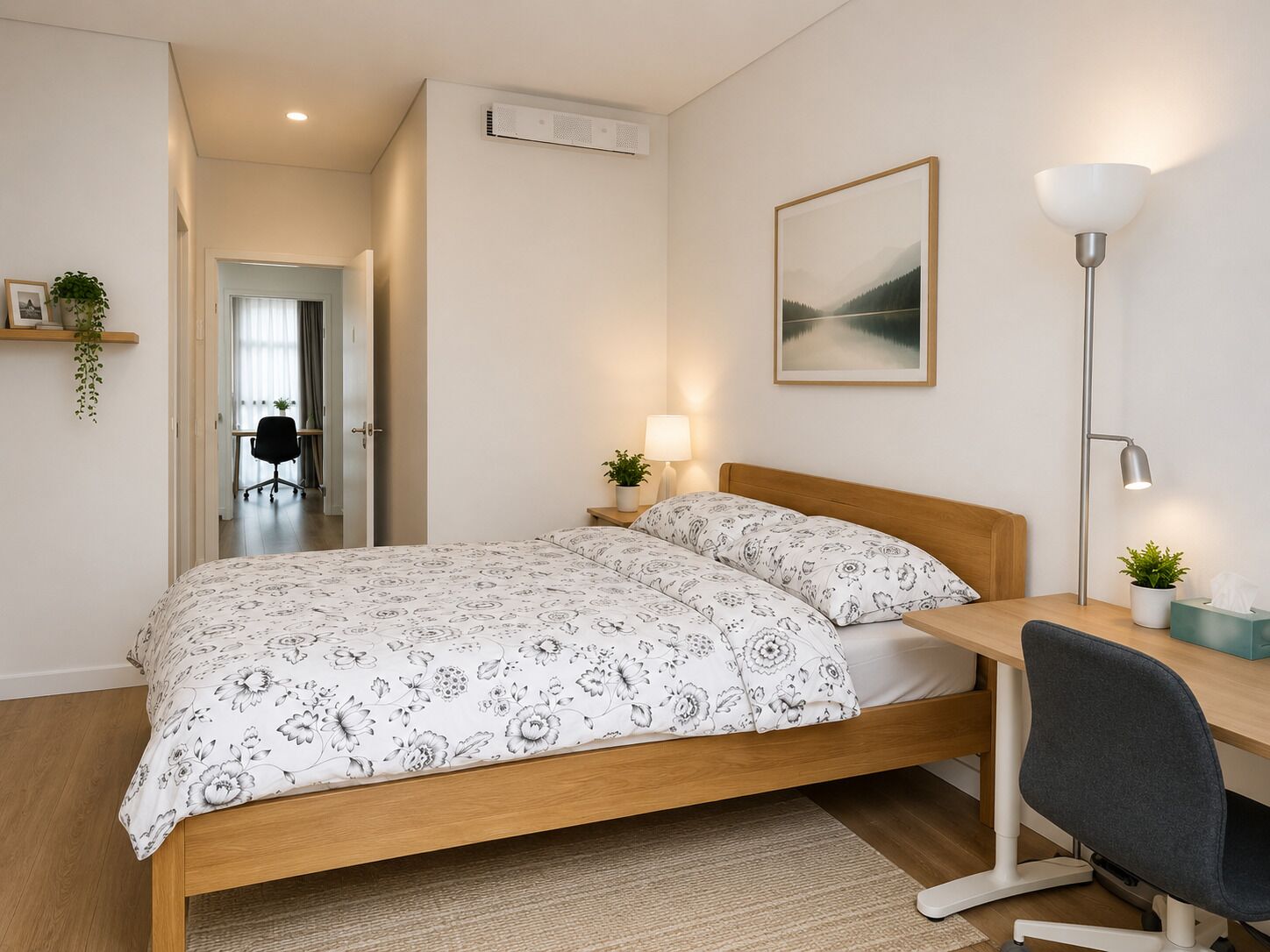 A bedroom with a bed, bedside tables, a desk, a chair, a lamp, and a picture on the wall.