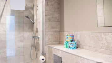 A modern bathroom with a shower, toilet, and sink.