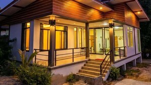 A modern two-story house with a covered porch and a staircase leading to the entrance. - Srithanu Villa (Tambon Ko Pha-ngan)