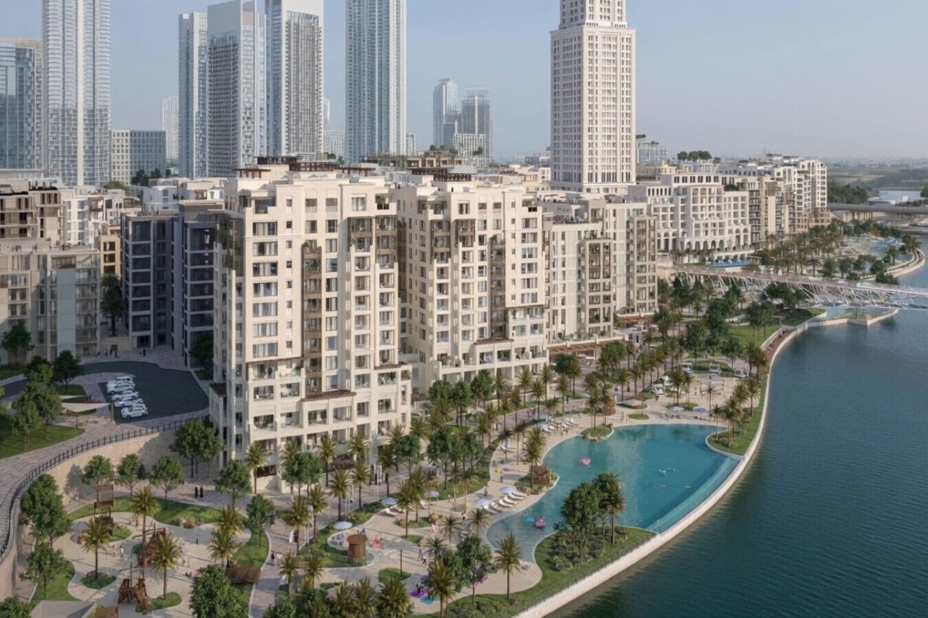 A high-rise residential building complex with a swimming pool and palm trees.