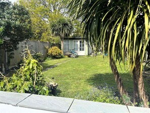 A residential backyard with a lawn, a small shed, and a bicycle. - Near the River and Marinas, quick walk to town Large Garden and off street parking for 3 cars (Lymington)