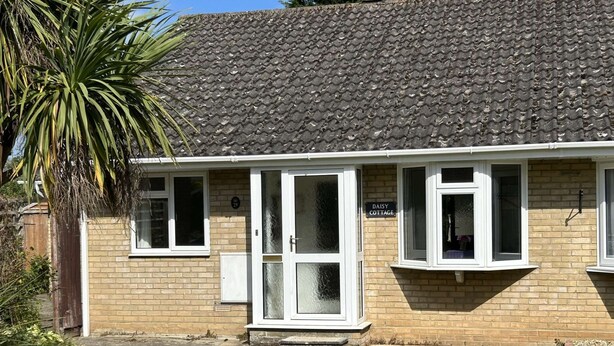 A two-story cottage with a tiled roof, a brick facade, and a small front garden. - Daisy Cottage by NewFo dot Rest (Lymington)
