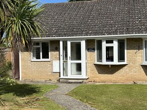 A two-story cottage with a tiled roof, a brick facade, and a small front garden. - Daisy Cottage by NewFo dot Rest (Lymington)