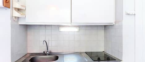 A kitchen with white cabinets, a stainless steel sink, and a dishwasher.
