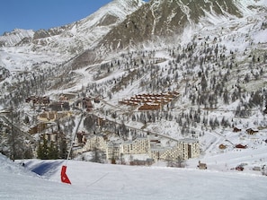 A snow-covered mountain resort with multiple buildings, including hotels and cabins, and ski slopes. - Charming Apartment in the Heart of the Hamlet (Isola 2000)
