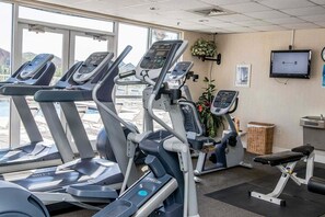 A gym with treadmills, a weight bench, and a TV on the wall. - Terrace At Pelican Beach 0804 3 Bedroom Condo (Destin)