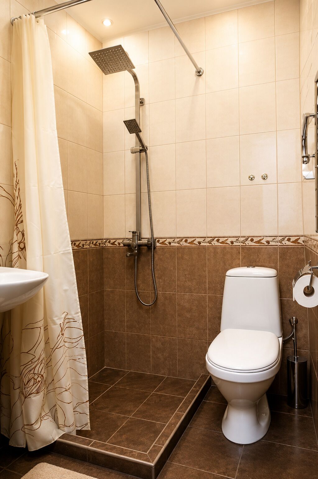 A bathroom with a shower, toilet, and sink.