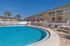 A swimming pool with lounge chairs and a white fence. - Sandpiper Cove 8242 (Destin)