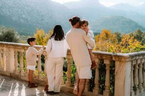 A family of four on a balcony overlooking a mountainous landscape. - The Dream Valley of Mallorca (Pollença)