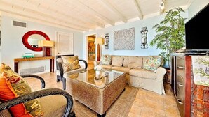 A living room with a sofa, armchairs, a coffee table, a television, and a plant. - On The Sand, Perfect 4 Families, Endless Sunset Views! (Dana Point)