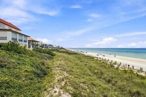 A coastal property with a beach view, a wooden walkway, and a building with a red roof. - 5BR 30A Beach House w Gulf Views & Private Beach Access ~ Sleeps 10 (Santa Rosa Beach)