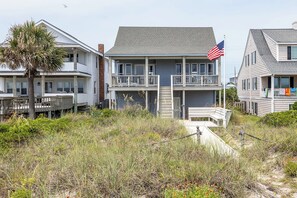 A beachfront property with a two-story house, a balcony, and a flag. - Blue Horizon - Oceanfront Home (Atlantic Beach)