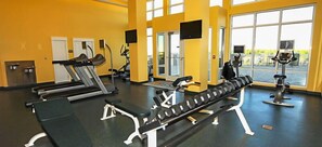 A gym with treadmills, a bench press, and weight machines. - Ocean Breeze! 5th Floor 2BR Gulf-Front Condo Sleeps 6 (Panama City Beach)