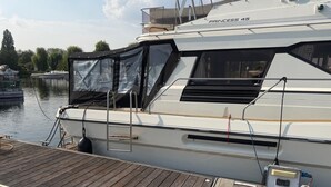 A white yacht named 'PRINCESS 45' docked at a wooden pier.