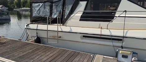 A white yacht named 'PRINCESS 45' docked at a wooden pier.