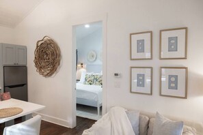 A modern interior with a dining area, a kitchen, and a living room.