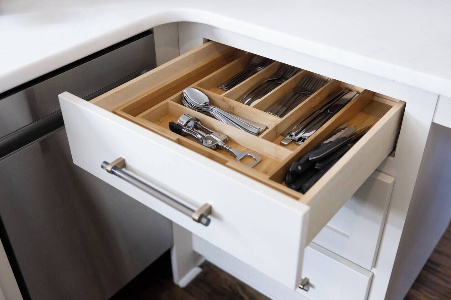 A kitchen drawer with utensils and cookware.