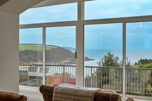 A room with a large window overlooking a coastal landscape. - Grand Salcombe Retreat (Salcombe)